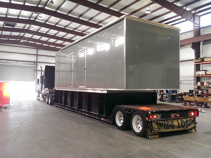 Enclosure loaded onto a trailer